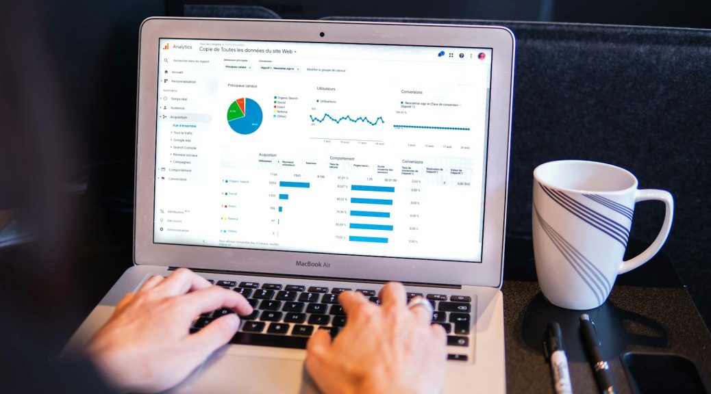 person using macbook pro on black table